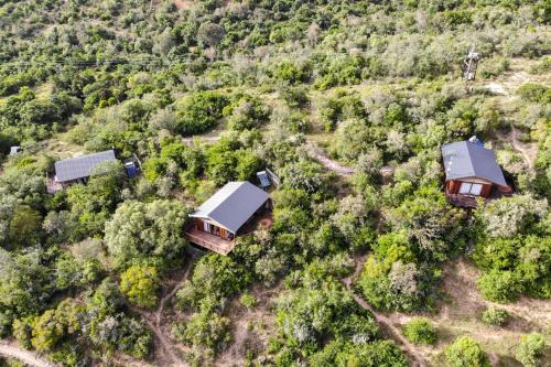 an aerial view of three houses in a forest at Barefoot Addo Elephant Lodge in Addo