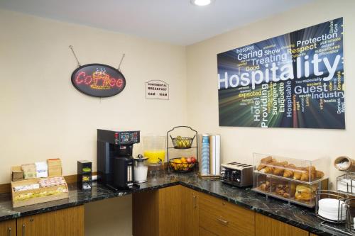 a kitchen with a counter top with a coffee machine at Skyview Motel in Fort Lee