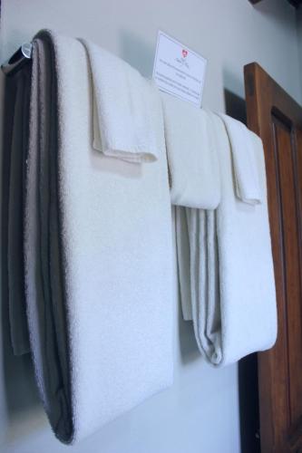 a row of white towels hanging on a rack at Hotel Amor y Paz in Real de Catorce
