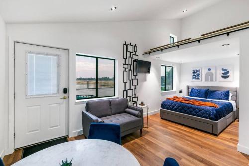 a bedroom with a bed and a couch and a chair at Mid-Century-Modern Airport Home in Sacramento