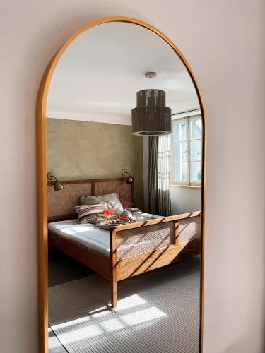 a bedroom with a bed and a large mirror at Schönhof im Weinviertel in Hadres