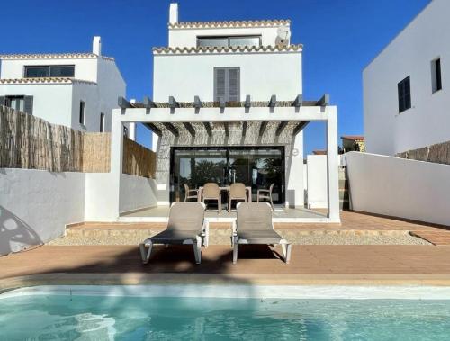 a villa with a swimming pool and a house at Villa Son Blanc 5 in Sa Caleta