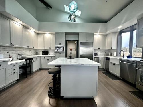 a large kitchen with white cabinets and a large island at Oceana Vista Escape - Beachside Haven in Dillon Beach