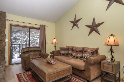 a living room with two couches and stars on the wall at Beaver Village Unit #0232R in Winter Park