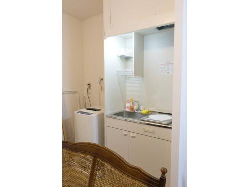 a kitchen with a sink and a refrigerator at Mini Hotel Shinjuku Front - Vacation STAY 89788v in Tokyo