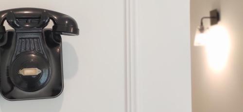 a black light on a wall next to a door at Le Petit Boutique Hotel in Santander