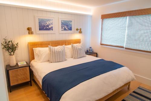 a bedroom with a large bed and a window at Harbor Lookout - Luxury Beach Home with Coastal Views - Walk to everything! in Newport Beach