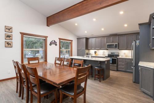 a kitchen with a wooden table and chairs in a kitchen at Aspen in Valemount