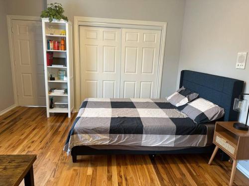 a bedroom with a bed and a book shelf at Luxury Stay in Montrose- The Italian Plaza in Houston