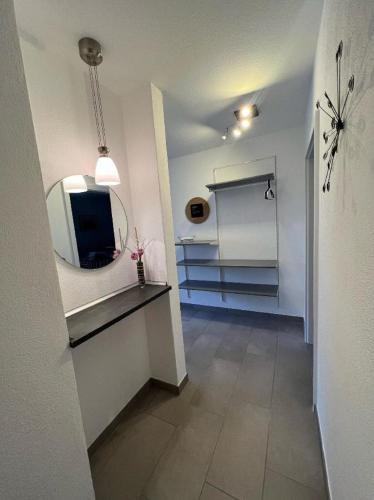 a bathroom with a mirror and a sink in a room at H.Aus.Zeit Ferienwohnungen Stockbauer in Regen
