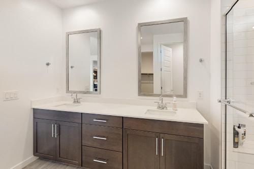 a bathroom with two sinks and two mirrors at Phoenix Star - Main House in Phoenix
