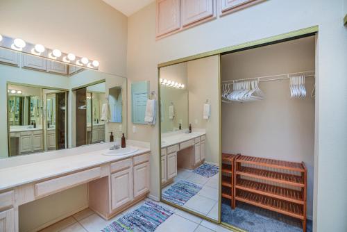 a bathroom with two sinks and two mirrors at Enchanted Hills Home with Sandia Mountain Views! in Rio Rancho