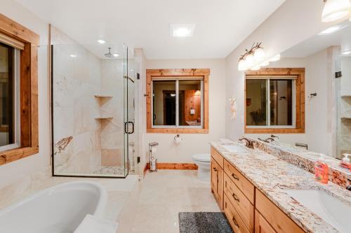 a bathroom with two sinks and a shower at Experience Montana Cabins - Lake View Luxury #7 & Dream Catcher Luxury #8 in Bigfork
