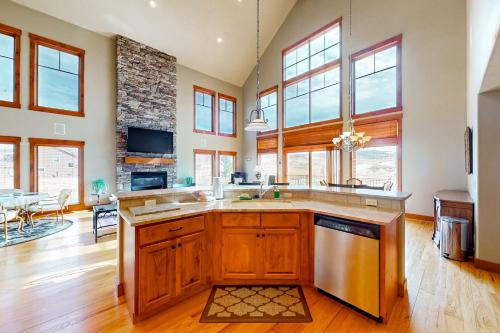 a large kitchen with wooden cabinets and a counter top at Saddle Ridge Ranch in Granby