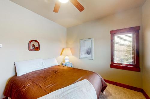 a bedroom with a bed and a window at Saddle Ridge Ranch in Granby