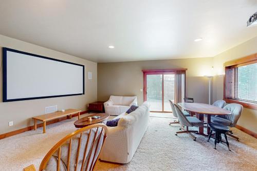 a living room with a white couch and a table at Saddle Ridge Ranch in Granby