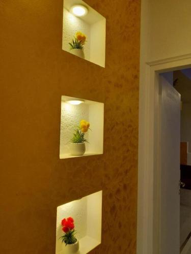 a wall with four pictures of flowers on it at Neli Carica in Visoko