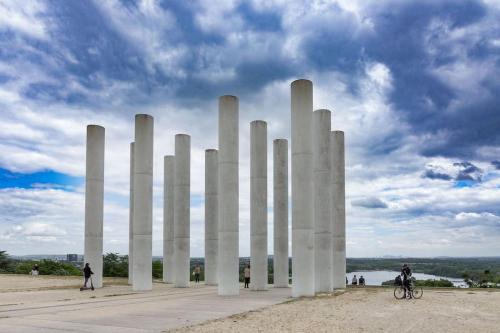 a group of tall white columns on a field at Cocon Eudenia - accès direct PARIS - 2 MIN RER - PARKING GRATUIT in Cergy