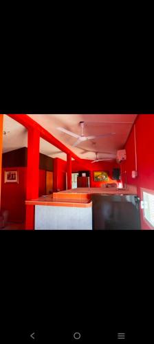 a kitchen with red walls and a red counter top at Departamento Kassandra in Puerto Peñasco