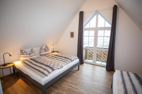 a bedroom with a bed and a large window at Ferienwohnung Zschopau Zentrum in Zschopau