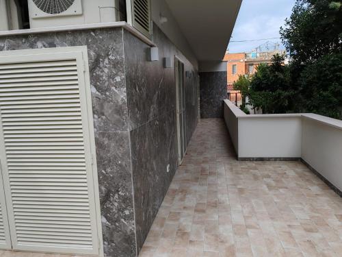 a walkway leading to a building with a garage at MÌLÙ BED and HOME in Bitonto