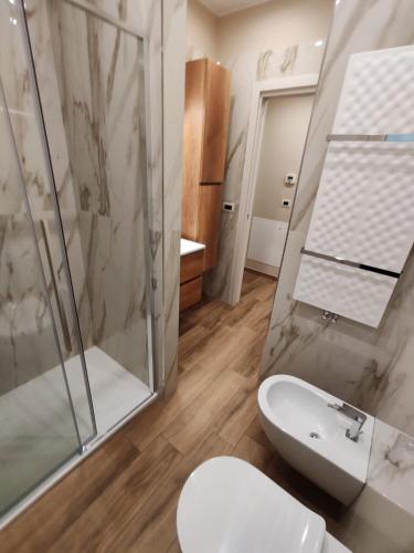 a bathroom with a shower and a toilet and a sink at MÌLÙ BED and HOME in Bitonto