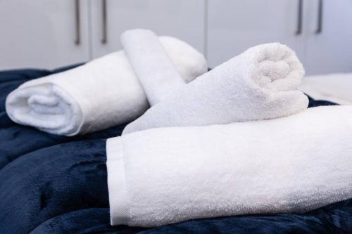 a pile of towels sitting on top of a bed at Luminous Luxury House in Pýli