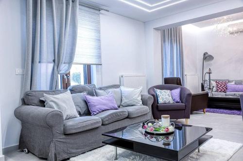 a living room with a couch and a table at Luminous Luxury House in Pýli