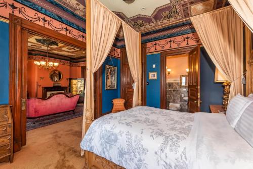 a bedroom with a bed in a room with blue walls at Chateau Tivoli Bed and Breakfast in San Francisco