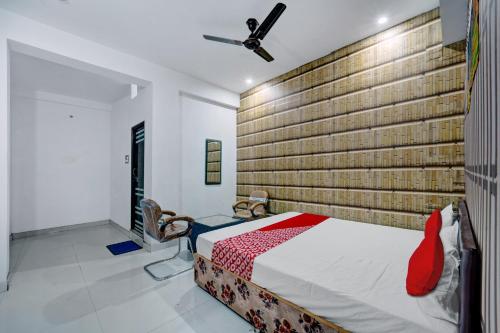 a bedroom with a bed and a brick wall at Flagship Hotel Blue Gram Inn in Patna
