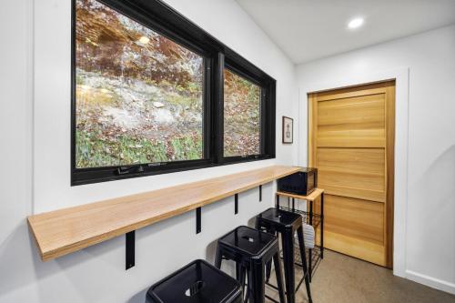 a home office with a window and stools at Tiny Cabin in RRG - The Naturalist in Rogers