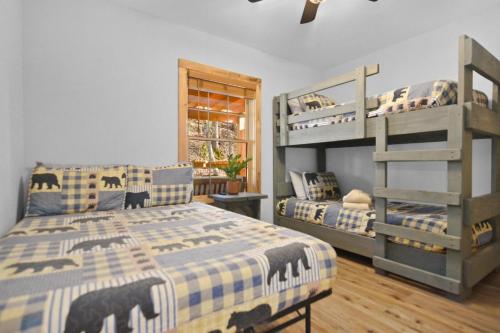a bedroom with two bunk beds and a window at Tsaliwood Cabin in Sevierville