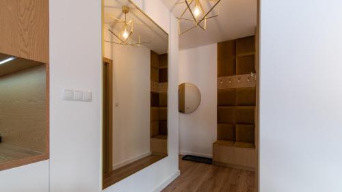 einen begehbaren Kleiderschrank mit Spiegel und Beleuchtung in der Unterkunft Apartament z WIDOKIEM in Wisła