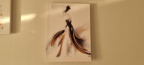 a painting of a woman in a dress on a wall at Comfy apartment- Sunny balcony in Tirana