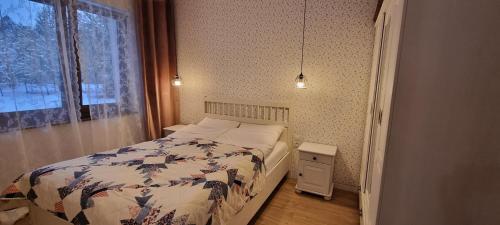 a small bedroom with a bed and a window at Borsk Sielanka in Borsk