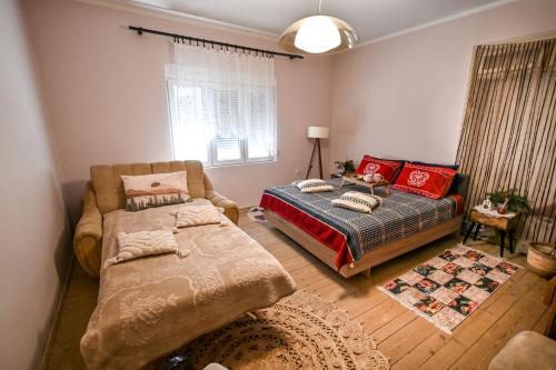a bedroom with a bed and a couch at Bukovički mir in Arandjelovac