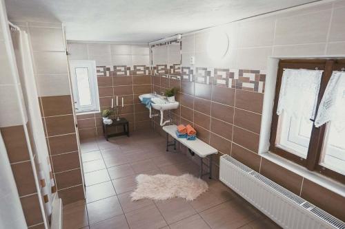 a large bathroom with a sink and a mirror at Horská bouda Šubišák in Loučná pod Klínovcem