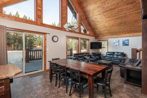 a living room with a wooden table and chairs at Cranberry in Valemount