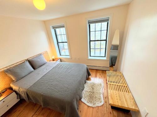 a bedroom with a bed and two windows at The Waltham Private Room & Bathroom JFK LGA 10min I 20min ManhattanPenn Station bullet-train in Queens