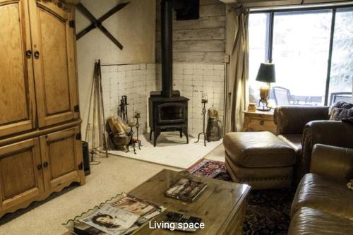 a living room with a couch and a fireplace at Interlochen #B9 in Vail