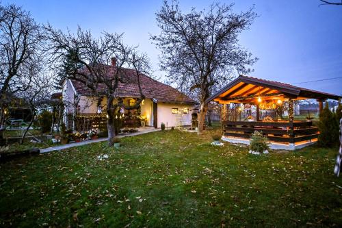 a house with a gazebo in a yard at Bukovički mir in Arandjelovac