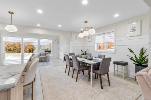 a dining room and living room with a table and chairs at The Rest at Potomac Farms in Ashburn