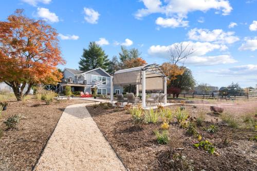 a garden with a gazebo in front of a house at The Rest at Potomac Farms in Ashburn