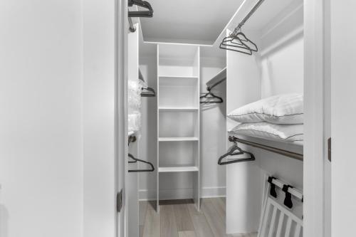a small room with a bed and some shelves at The Rest at Potomac Farms in Ashburn