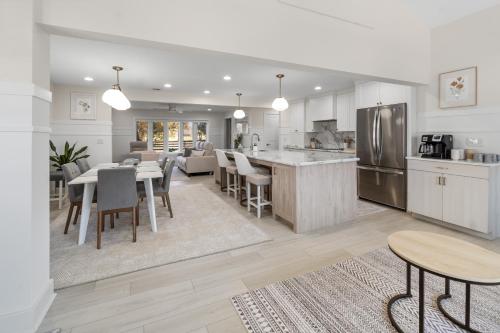 a kitchen and living room with a table and chairs at The Rest at Potomac Farms in Ashburn