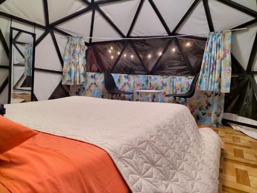 a bedroom with a bed in a tent at BORUKA BnB in Alajuela