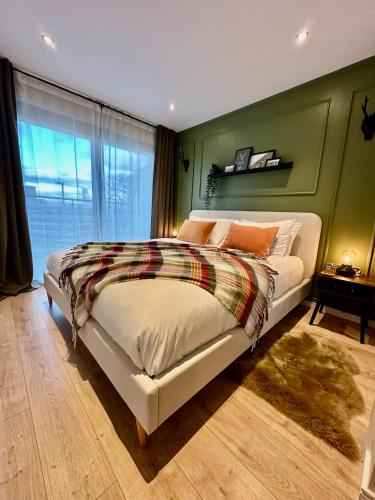 a bedroom with a bed and a large window at The Stag City Centre Cosy 1 Bed Long Term Stays Welcome in Plymouth