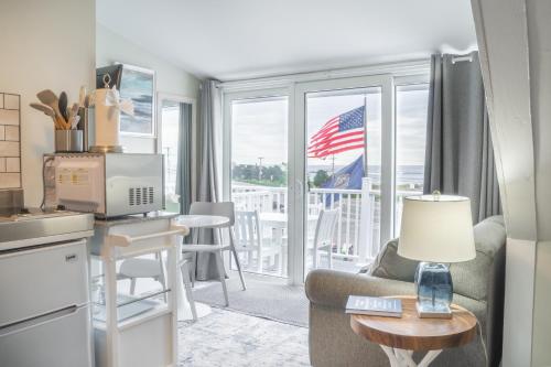 a living room with a couch and a table with a desk at 935 Ocean, a Beachside Inn in Hampton
