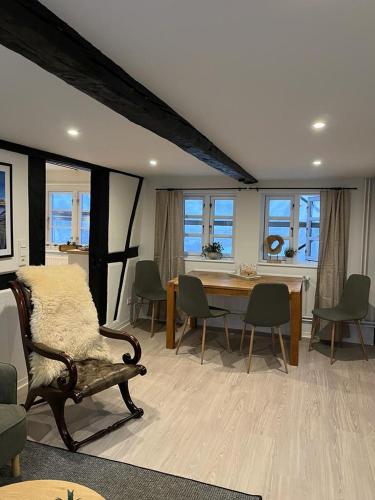 a living room with a couch and a table and chairs at Zeppelin Koje in Flensburg
