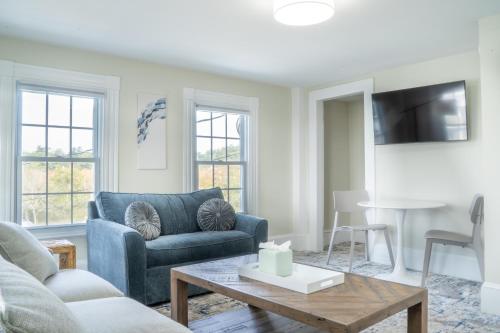 a living room with a couch and a table at 935 Ocean, a Beachside Inn in Hampton